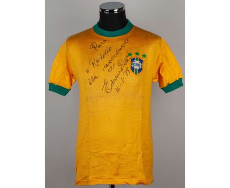 Pelé signed yellow Brazil No.10 shirt, by Athleta, short-sleeved, three stars, signed with a dedication and dated 16/1/74.Pro