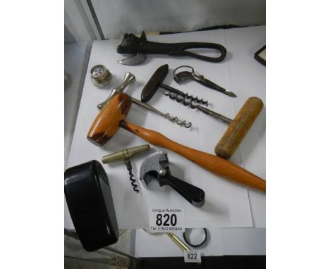 A mixed lot of bottle openers, corkscrews and other items including Wilkinson Sword.