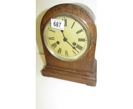 An Edwardian oak mantle clock.
