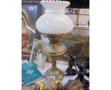 A brass oil lamp complete with shade, COLLECT ONLY.