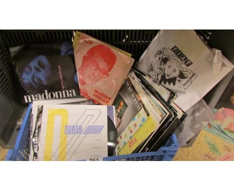 A tray of 45 rpm records including Buddy Holly, Madonna etc.,
