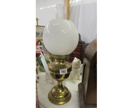 An Edwardian brass oil lamp complete with shade, COLLECT ONLY.