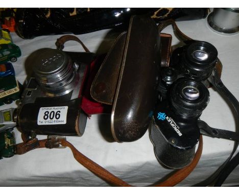 A vintage Seiko Aries camera and a pair of Beroflex 8 x 30 binoculars.