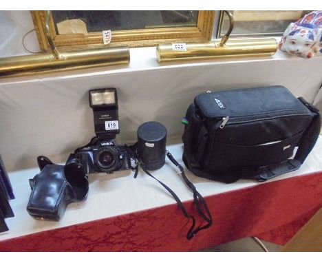 A Minolta camera, lens etc in bag.