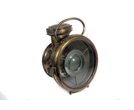 A large Early 20th century brass acetylene Projector Road-lamp c1908: unknown maker, having large bullseye lens reflector-bac