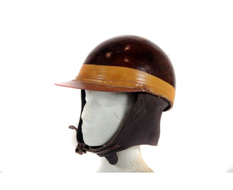Goodwood - An original race-worn crash-helmet c1950s: of laminated cloth & shellac construction with attached peak with moles