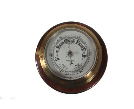 A large brass-cased marine aneroid barometer c1920s, by S. Neill Ltd Belfast, bevel-glazed front-opening polished brass case,