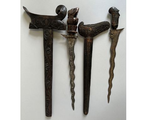 TWO MALAYSIAN DAGGERS (KRIS), 20TH CENTURY the first with wavy blade chiselled over its length with a serpent, plaited selut,