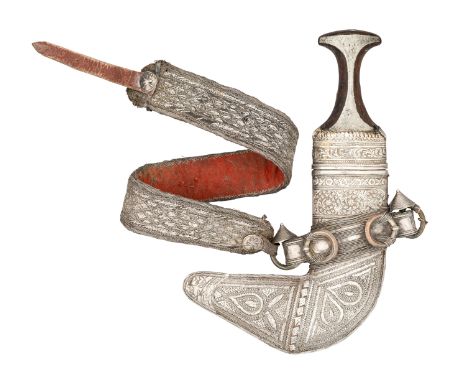 AN ARAB DAGGER (JAMBIYA) WITH SILVER-MOUNTED HILT, EARLY 20TH CENTURY with curved double-edged blade formed with a medial rid
