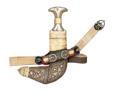 AN ARAB DAGGER (JAMBIYA) WITH SILVER-GILT MOUNTED RHINOCEROS HORN HILT, EARLY 20TH CENTURY with curved double-edged blade for