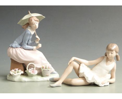 Two Nao figurines, one holding a parasol with baskets of flowers, the other a reclining ballerina, with box, tallest 21cm&nbs