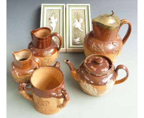 Royal Doulton and Doulton Lambeth stoneware jugs, tyg and teapot and a pair of continental relief moulded plaques decorated w