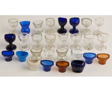 Twenty-eight glass, ceramic and other 19thC and later eye baths including Bristol blue.&nbsp;