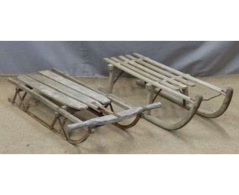 Two vintage sledges, one by Harrods, length 103cm