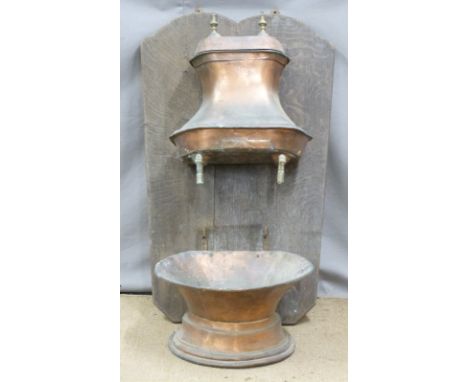 Continental copper basin and cistern mounted on oak panel, the cistern with engraved armorial and laurel leaf surround, heigh