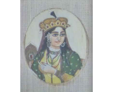 A 19thC Indian ivory portrait miniature of a lady with headdress, 8 x 6cm, in period frame