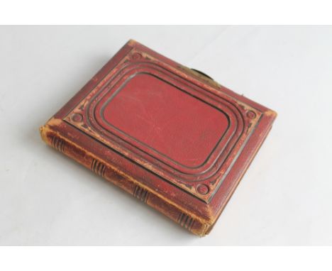 A MARION & CO'S PHOTOGRAPH ALBUM containing various cartes de visite and cabinet cards in slide inserts with hand written por