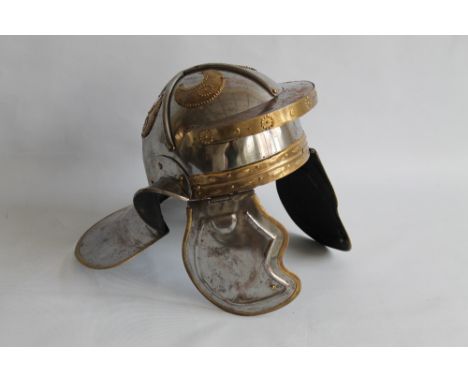 A REPRODUCTION ROMAN MILITARY HELMET, steel with brass decoration