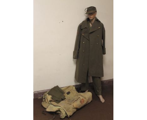 AN OFFICER'S UNIFORM WITH BADGE FOR A CAPTAIN IN THE WORCESTERSHIRE REGIMENT, together with a great coat, all displayed on a 