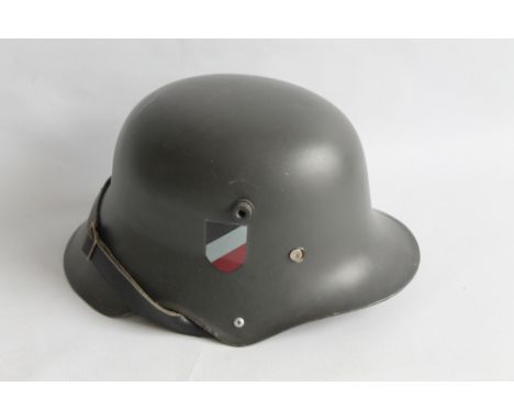 A REPRODUCTION GERMAN HELMET AND LINER