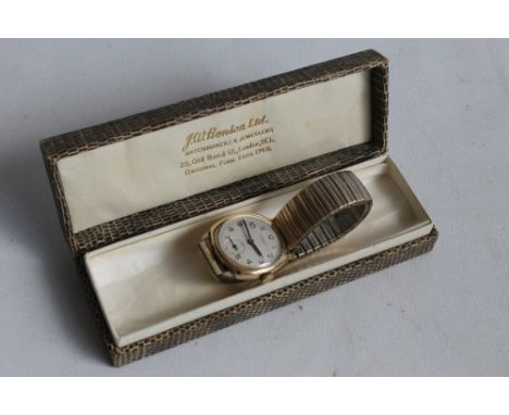 A GENTLEMAN'S 'J. W. BENSON' 9CT GOLD WRIST WATCH, cushion shaped case, with silvered dial, black Arabic numeral markers (eng