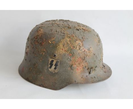 A REPRODUCTION THIRD REICH GERMAN HELMET, with S.S. decal and applied camouflage 