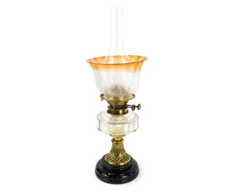 A 19thC brass oil lamp, with an orange and butterfly floral shade, marked Spink and Sons, 38cm high. 