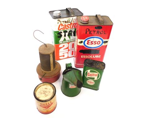 A group of oil cans, comprising a Castrol XL oil can, SO Lube 30 can, Castrol miniature can, Castrol can, carry lamp, and a S