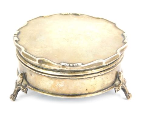 A George V silver trinket box, circular fluted top on tripod base, Birmingham 1928, with a velvet lined interior, 6.5cm wide,