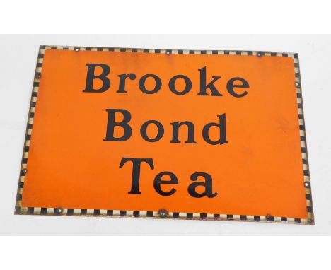 A Brooke Bond Tea enamel advertising sign, on orange ground with chequered border, 51cm x 76cm.