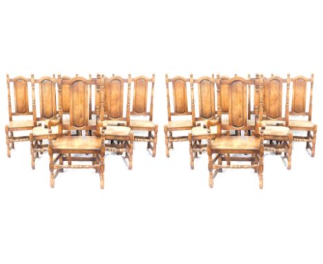 A set of fourteen oak dining chairs, each with an oval back on bobbin turned supports, comprising two carvers.