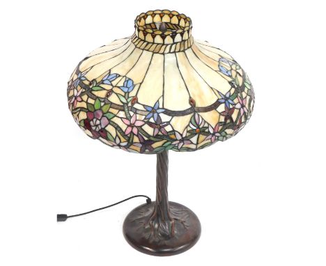 A Tiffany style desk lamp, the outswept cream domed floral shade with applied orange cabochon beads, on a leaf moulded base, 