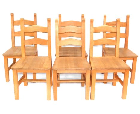 A set of six beech ladder back chairs, each with a solid seat. 