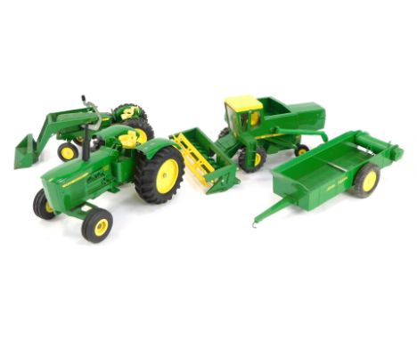 John Deere diecast agricultural vehicles, comprising spreader, toy combine, utility tractor with end loader and the Ertl Toys