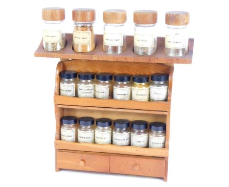 A pine hanging kitchen spice rack, and various glass bottles, 35cm high, 38cm wide.
