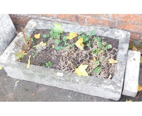 A rectangular stone hewn planter, and feet, 15cm high, 75cm wide, 46cm deep. 