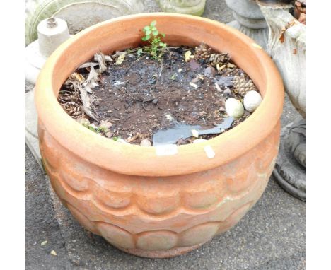 A terracotta planter, of arched design with a lobed top, 45cm high, 51cm diameter.