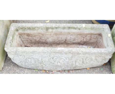 A reconstituted stone planter, rectangular with Greek god details, 25cm high, 71cm wide, 23cm deep.