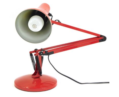 A red anglepoise desk lamp, 90cm high, fully extended.