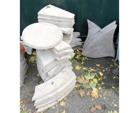 Various light stone patio pieces, discs, out of orders, etc., and twelve taupe paving stones. 