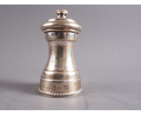 A silver pepper mill, 4" h x 2 1/8" diaCondition:The grinder is extremely stiff and does not fully rotate, the underside has 