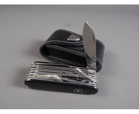 A Victorinox Swiss Army "Champ" pocket knife with black scales, in leather pouch