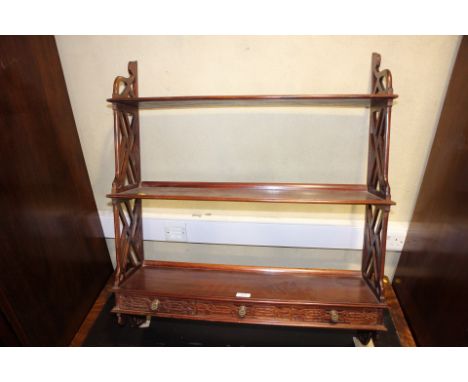A Georgian style open wall shelf with three shelves over three drawers with blind fretwork fronts, 30" wide overall