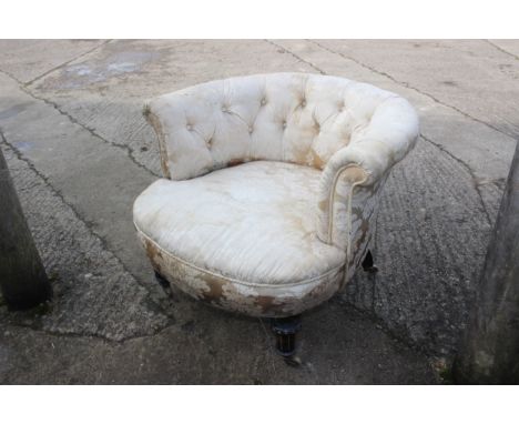 A Gillow's tub seat bedroom chair, button upholstered in a cream brocade, on ebonised and gilt castored supports