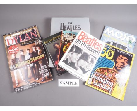 A collection of Jimi Hendrix and Beatles volumes, and other rock music vols and magazines