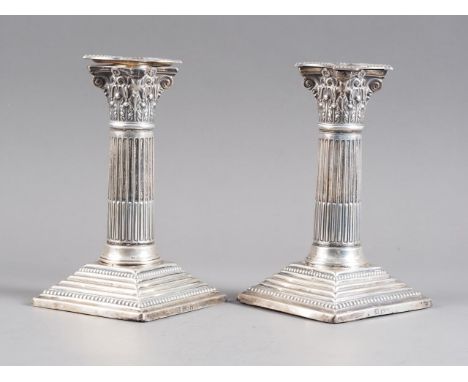 A pair of Victorian silver Corinthian column dwarf candlesticks, on stepped square foot, marks rubbed, London 1899Condition:T