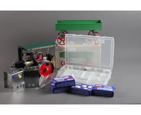 A Mamod steam roller, in box, a Mamod open wagon, in box, a quantity of spare parts and four boxes of twenty waxed solid fuel