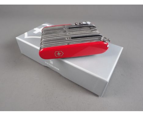 A Victorinox "Swiss Champ XXL" 73 function pocket knife with red scales, in presentation box