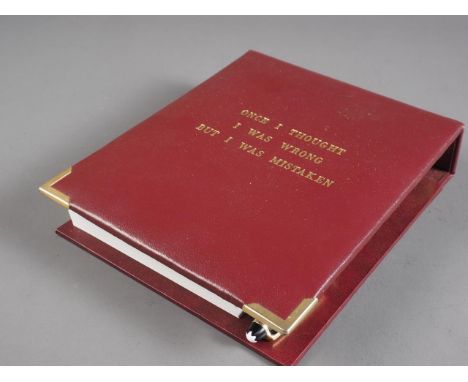An Asprey red leather and gilt metal mounted notepad, pen holder and Montblanc ballpoint pen, front cover decorated with "Onc