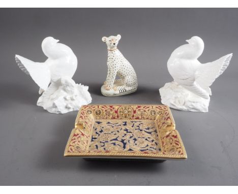 A Royal Crown Derby blanc-de-chine model dove, 6 3/4" high, another similar, a model cheetah and an ashtray with gilt scrolle